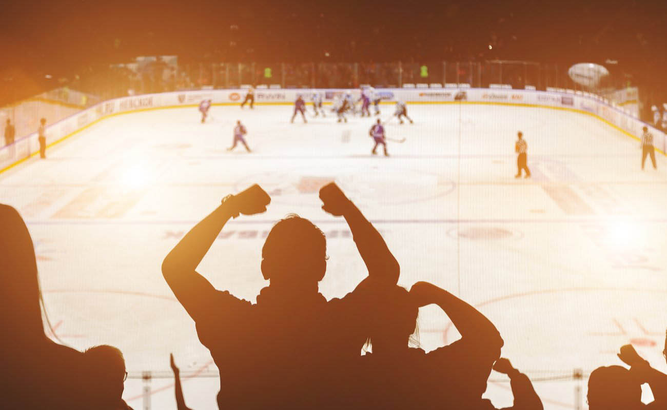 Hockey fans cheering in the shadow