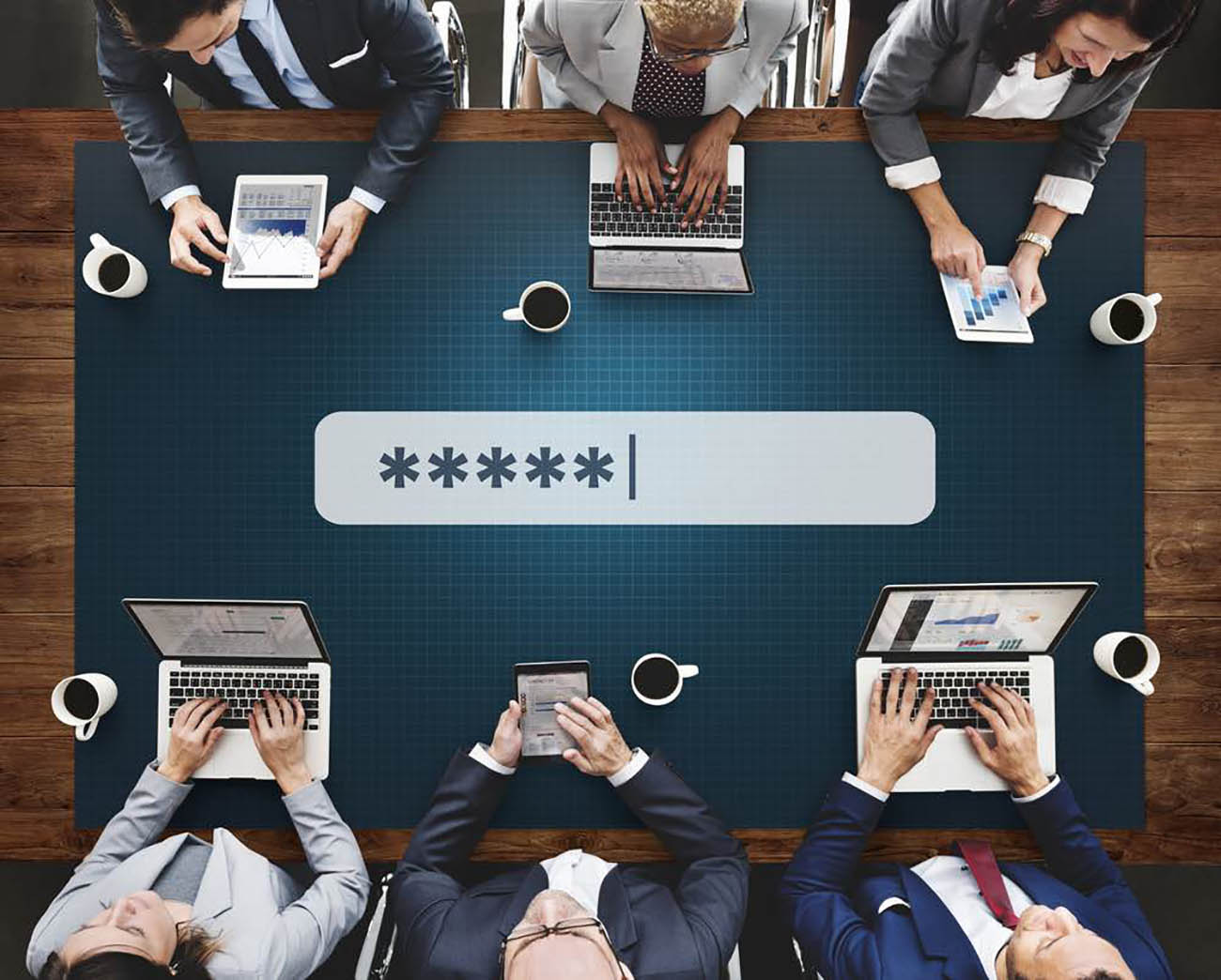 executives_sitting_around_a_table_navigating_digital_devices