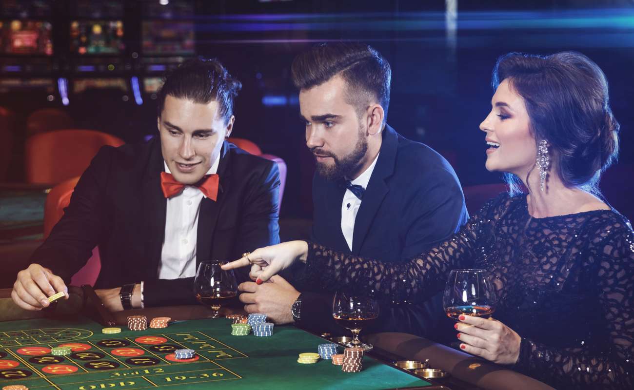 young successful people playing poker in a casino