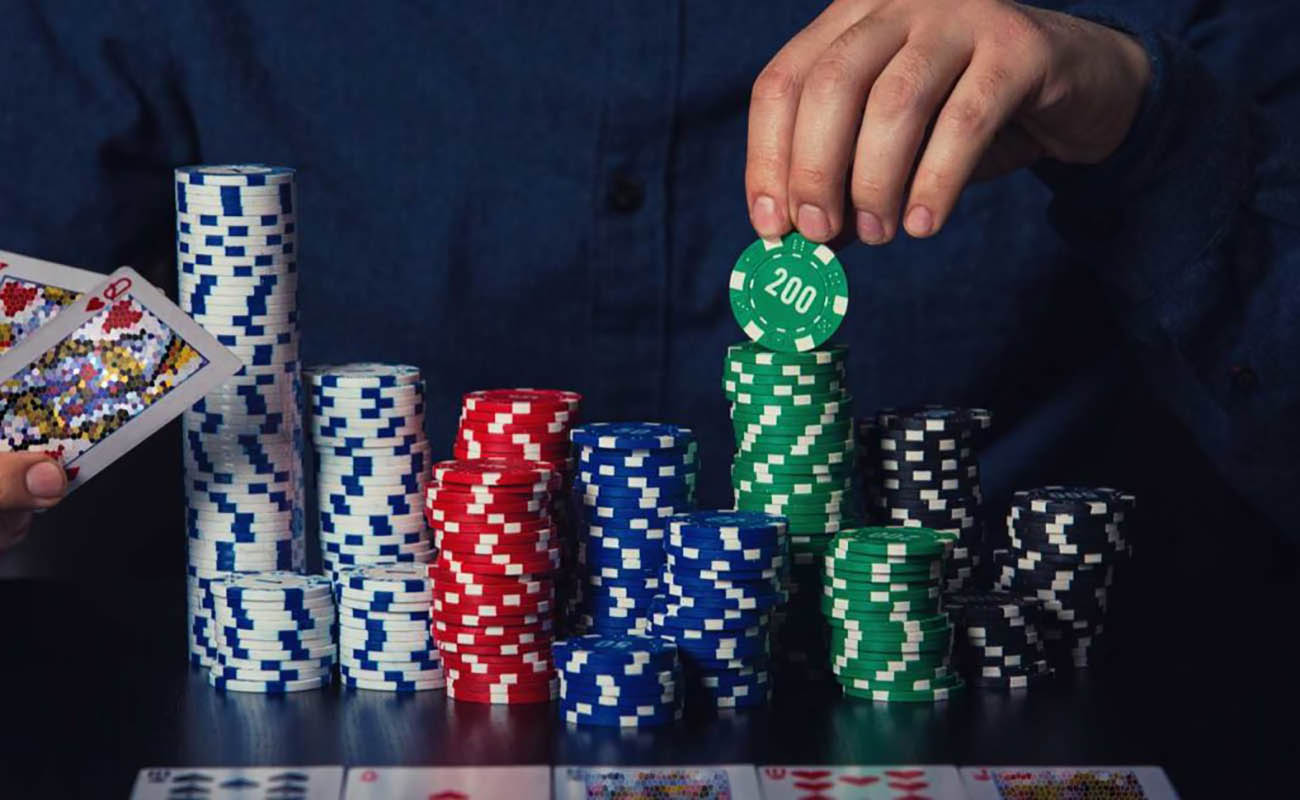 male hand stacking up piles of poker chips