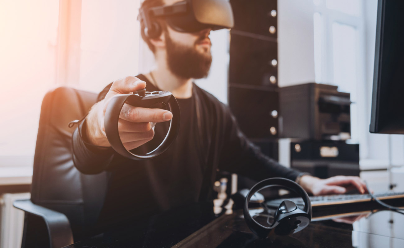 man playing virtual reality game with headset and consoles