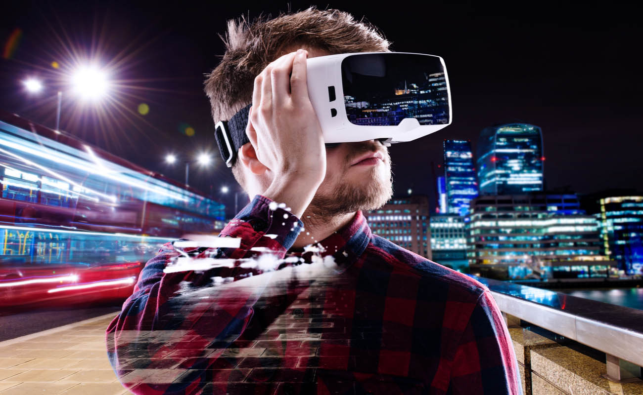 man wearing virtual reality headset with blurred city around him 