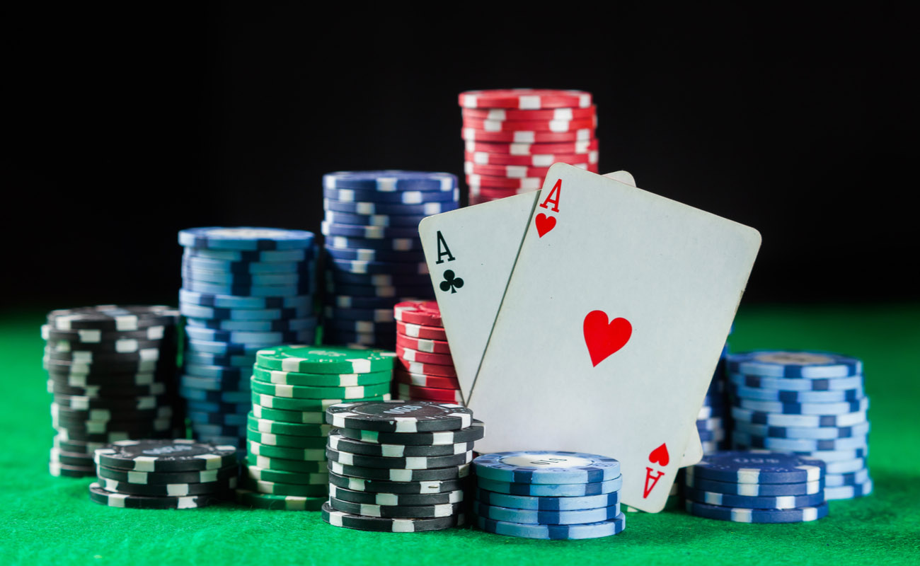 pile of poker chips and two aces symbolizing poker 