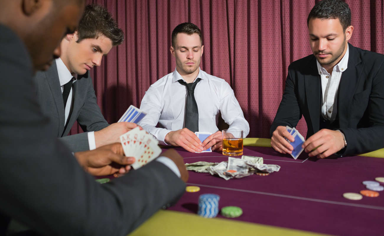 Men playing high stakes poker game in casino