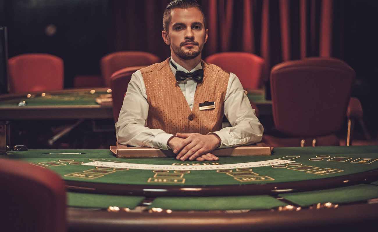 Croupier behind a gambling table in a casino.