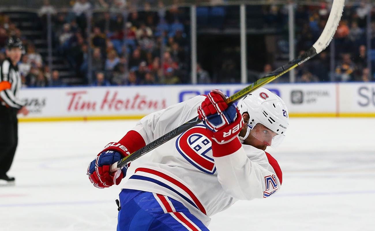 Montreal Canadiens player on ice swings hockey stick