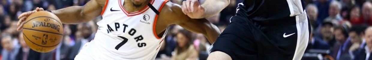 Kyle Lowry #7 of the Toronto Raptors dribbles the ball as Jakob Poeltl #25 of the San Antonio Spurs defends during the first half of an NBA game at Scotiabank Arena on January 12, 2020 in Toronto, Canada.