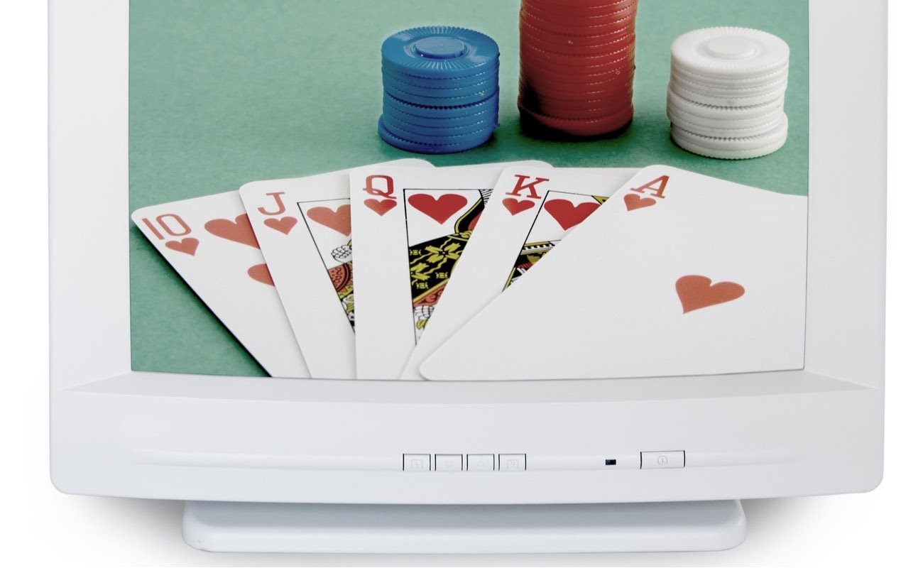 Closeup of old computer showing poker cards and chips on the screen against white background