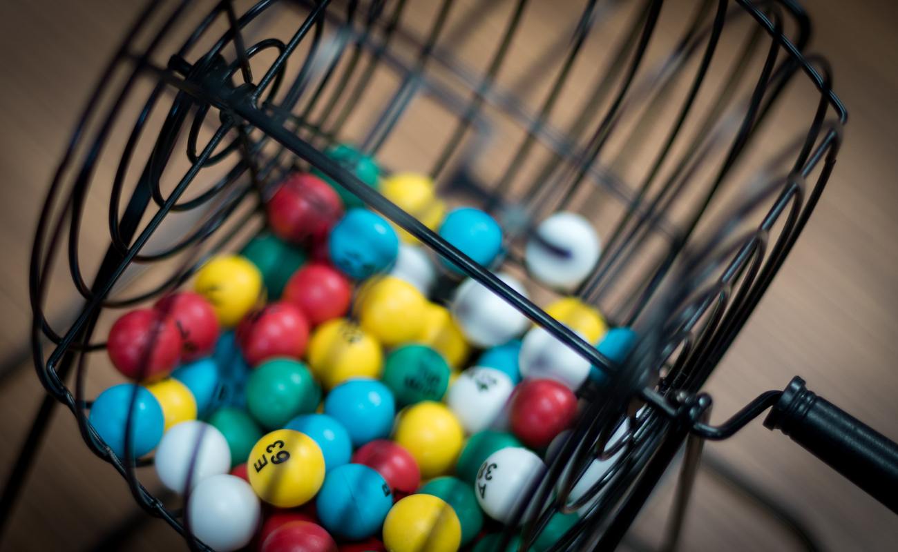 A close-up of a bingo cage filled with numbered bingo balls.