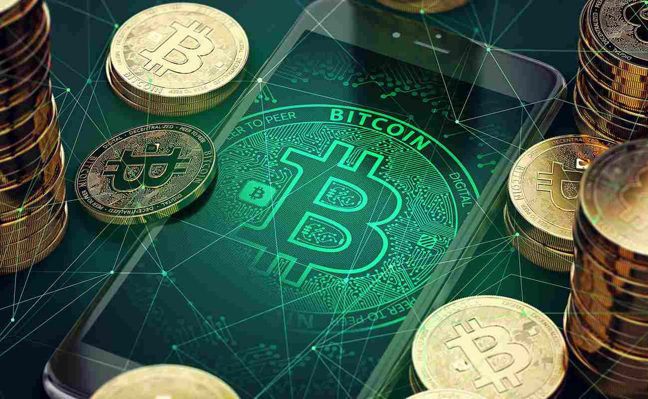 The Bitcoin Logo On a Smartphone Surrounded by Golden Coins