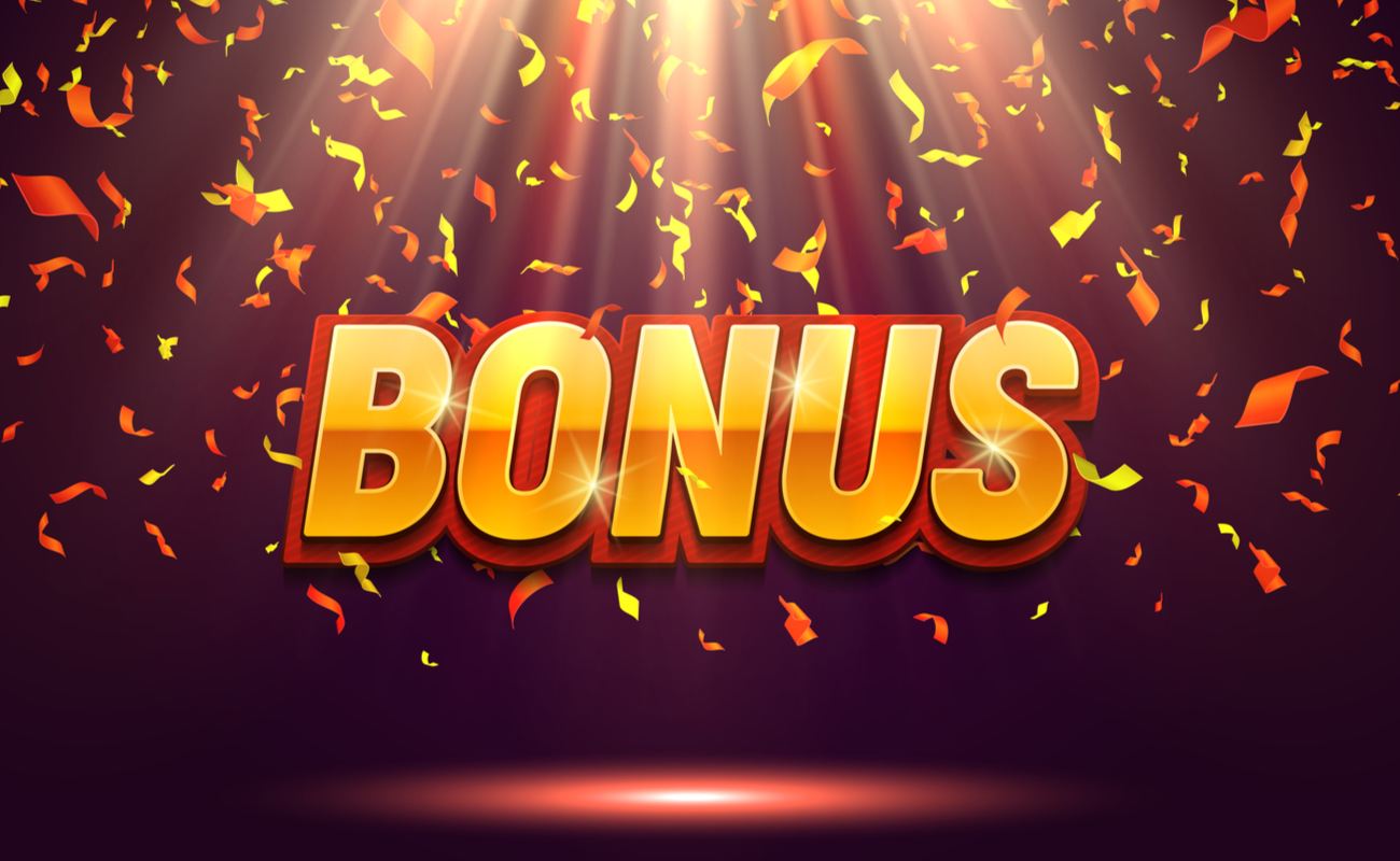 An illustration of the word ‘bonus’ is seen sitting in the center of a spotlight while confetti falls down around it.