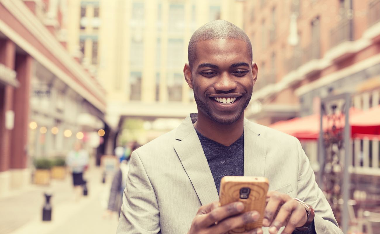 Young professional man using a smartphone in the city.