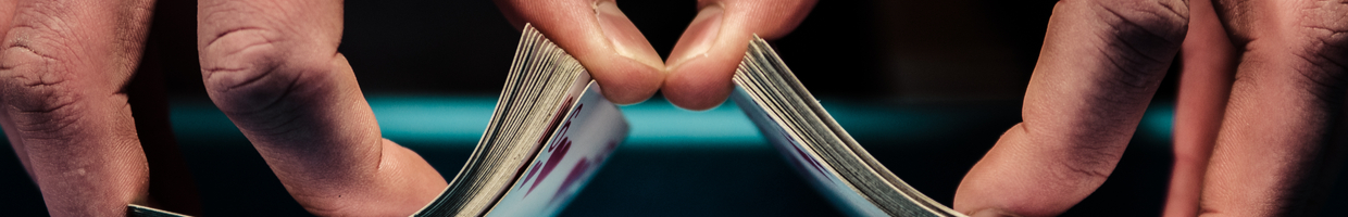 Close-up of a dealer’s hands shuffling a deck of cards.