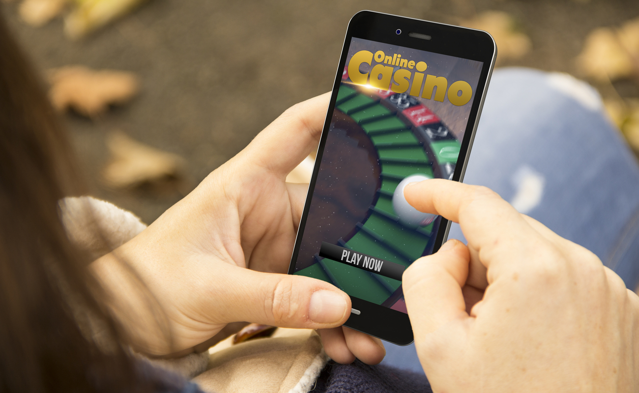 A woman with an online casino site open on her smartphone.