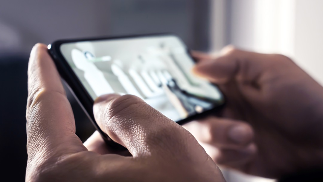 A person playing a shooting game on their phone.