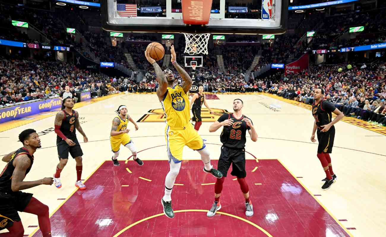 Marquese Chriss of Golden State Warriors shoots over Larry Nance Jr. during game at Rocket Mortgage Fieldhouse