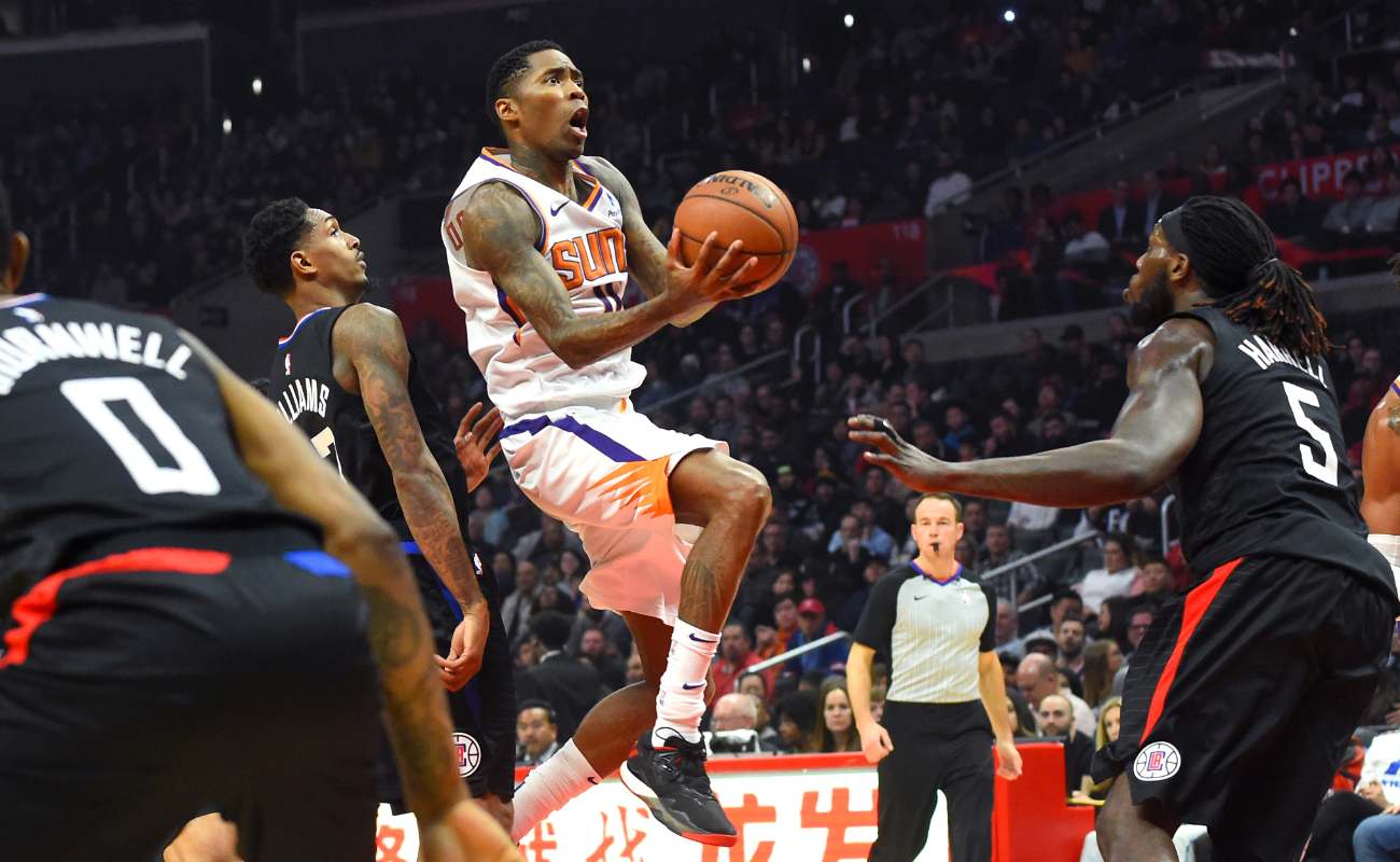 Jamal Crawford of Phoenix Sun drives basketball to the basket during game at Staples Center
