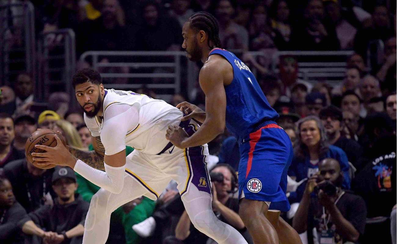 Anthony Davis of Los Angeles Lakers keeps basketball from Kawhi Leonard of LA Clippers at Staples Center