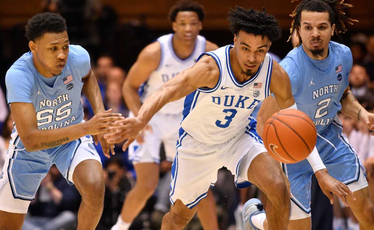 Tre Jones of Duke Blue Devils battles North Carolina Tar Heels for a loose ball during game
