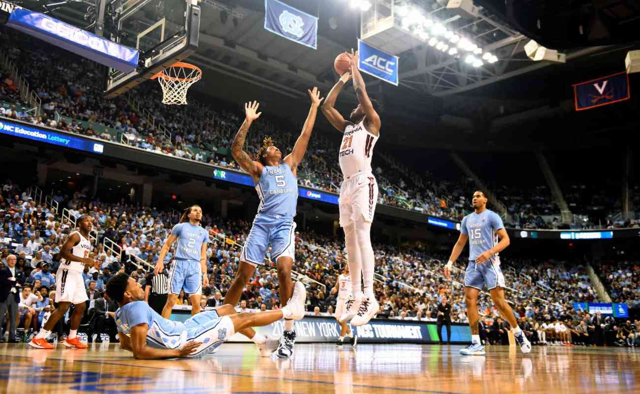John Ojiako of Virginia Tech Hokies attempts a shot against Armando Bacot of North Carolina Tar Heels