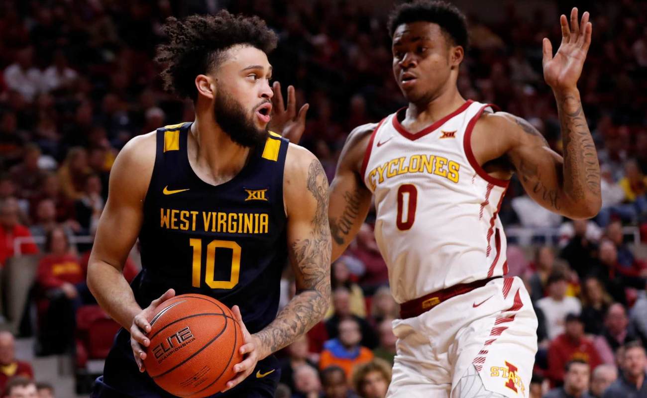Jermaine Haley of West Virginia Mountaineers passes the ball as Zion Griffin of Iowa State Cyclones defends