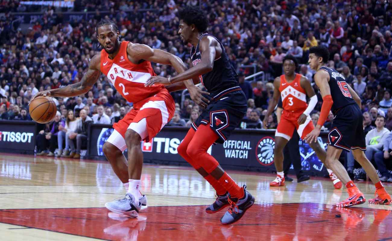 Kawhi Leonard #2 of Toronto Raptors dribbles ball as Justin Holiday #7 of Chicago Bulls defends during NBA game on December 30, 2018 in Toronto