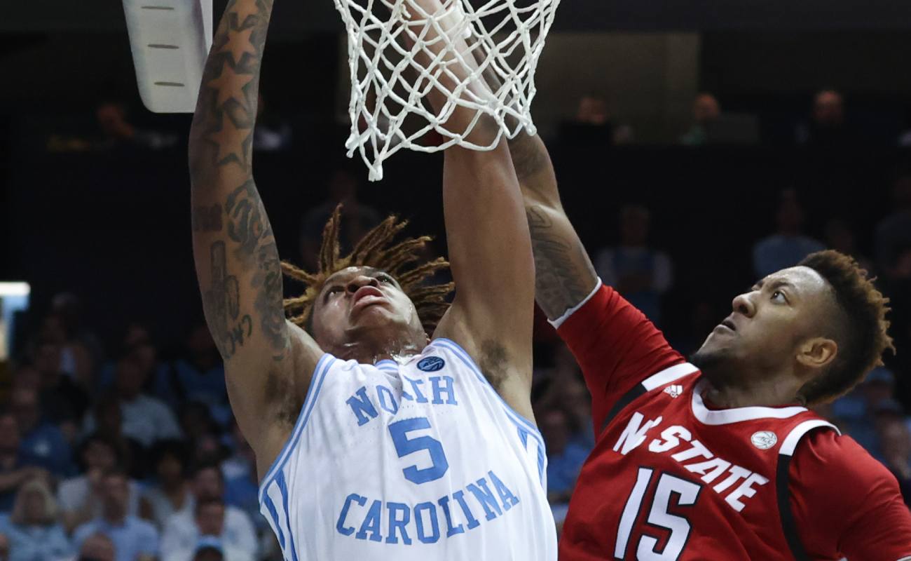 Manny Bates #15 of North Carolina State University blocks shot by Armando Bacot #5 of University of North Carolina during basketball game