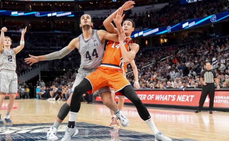 Omer Yurtseven of Georgetown Hoyas fights for position with Jesse Edwards of Syracuse Orange during a college basketball game