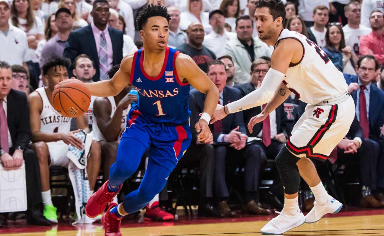 Guard Devon Dotson #1 of the Kansas Jayhawks drives against guard Davide Moretti #25 of the Texas Tech Red Raiders