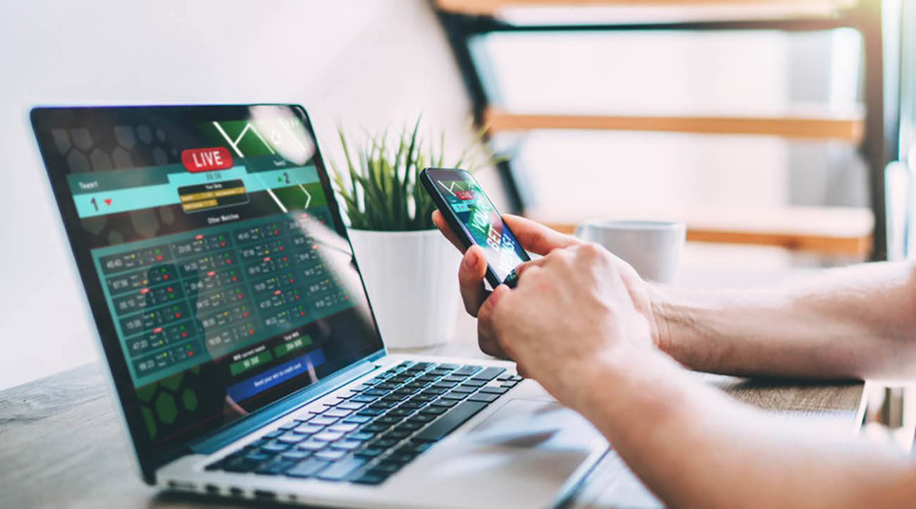 Men hands betting online using smartphone