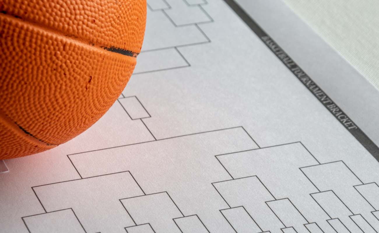 Blank bracket grid on white paper with basketball on top