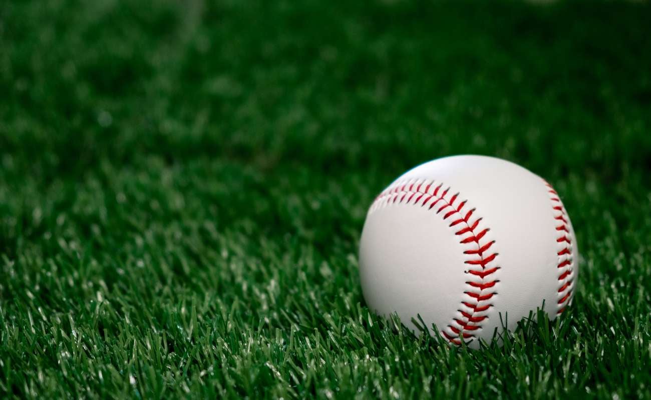 Baseball sitting on green grass