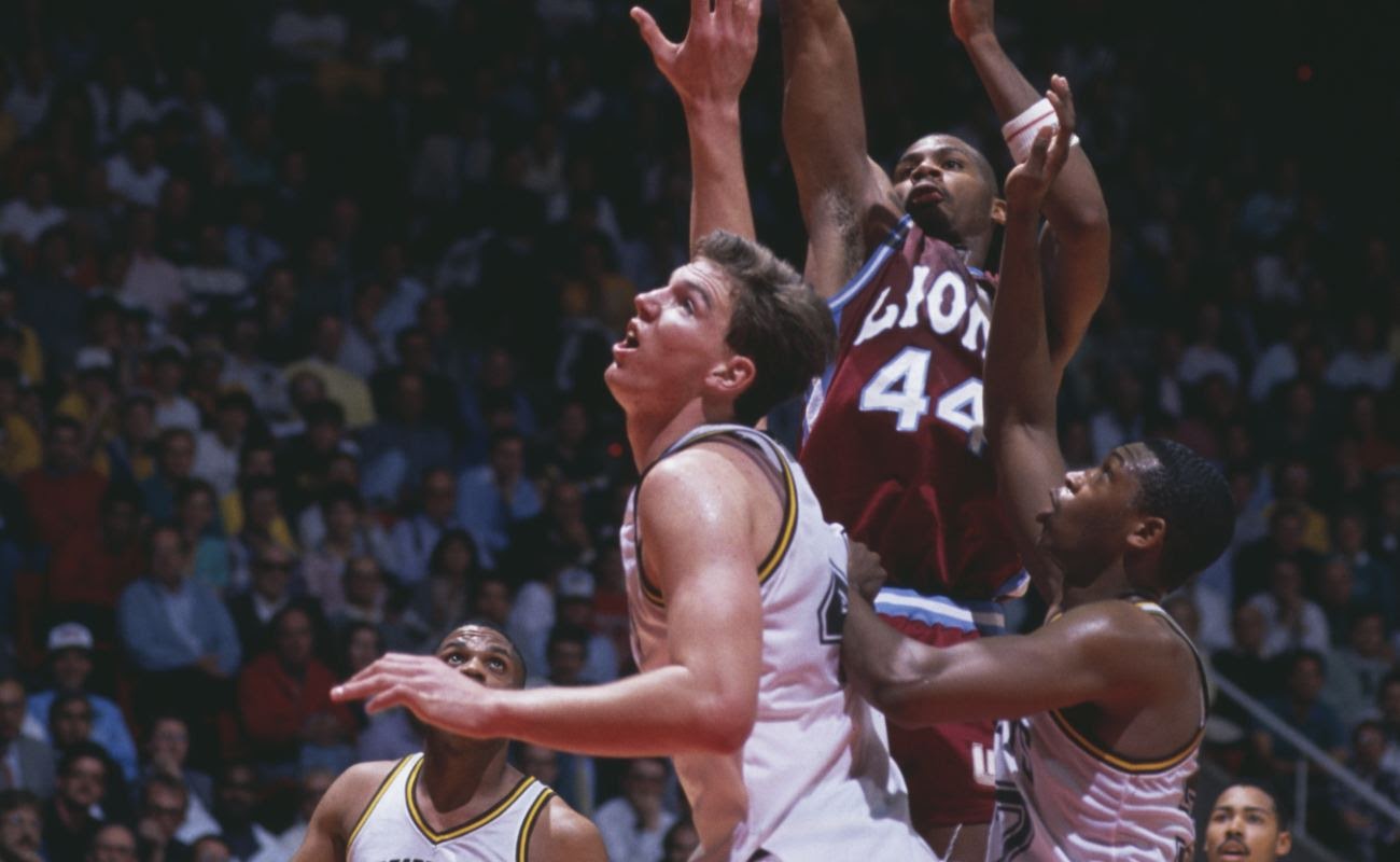 Hank Gathers #44 of Loyola Marymount University Lions jumps above the University of Wyoming Cowboys during NCAA Western Athletic Conference tournament 1988