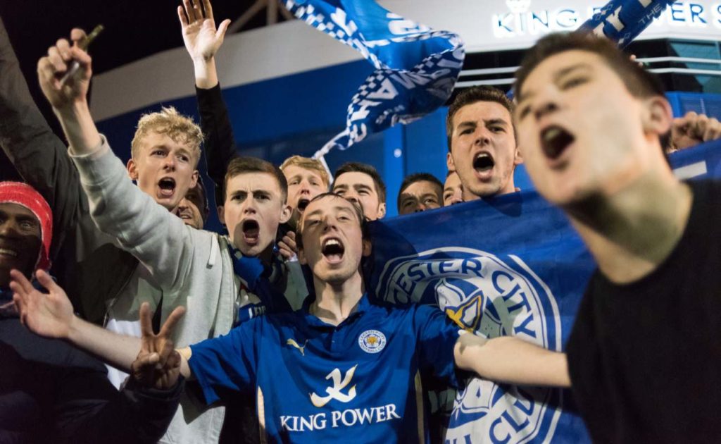 Leicester city fans out on the streets celebrating the premier league title