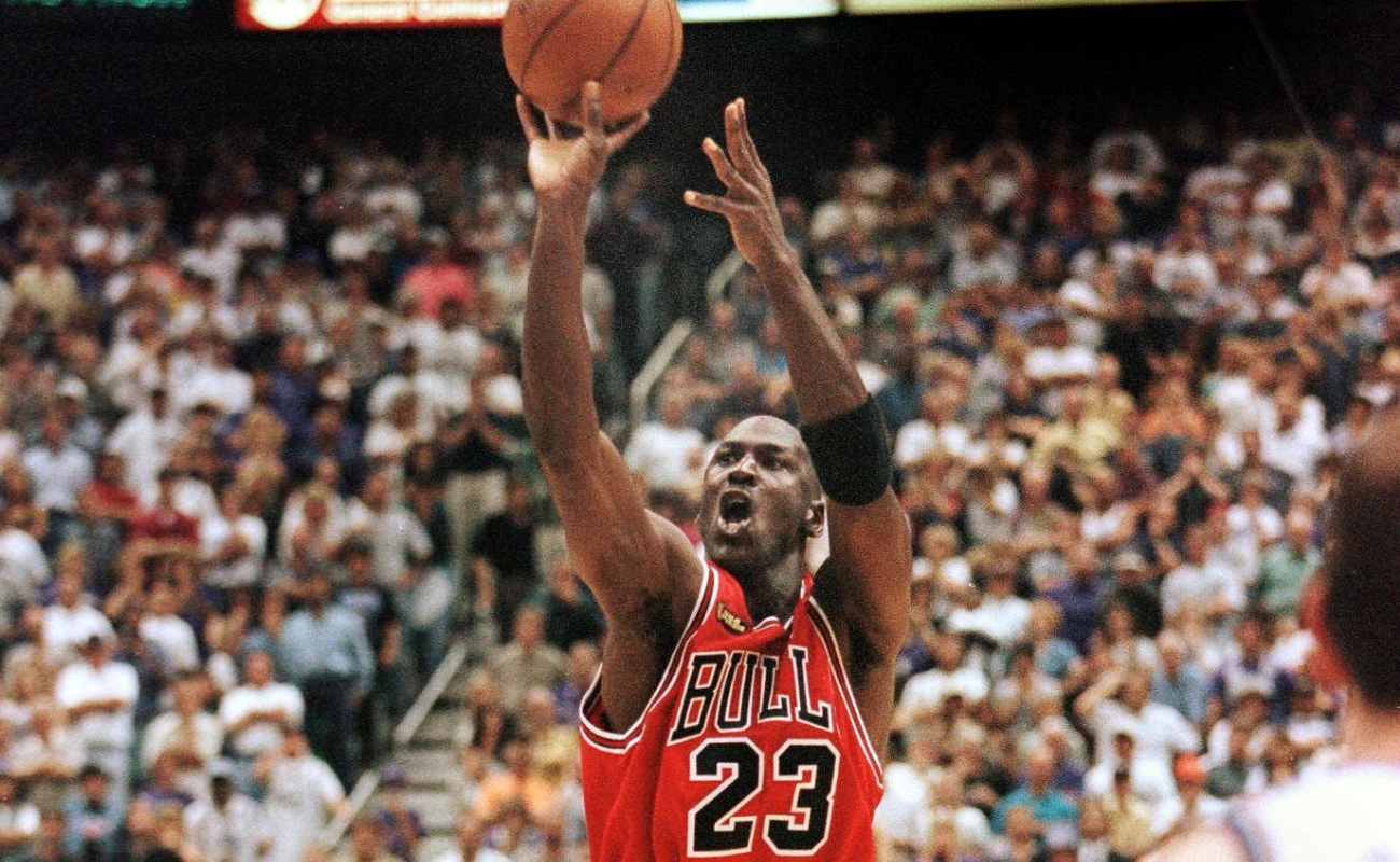 Michael Jordan of Chicago Bulls aims and shoots the game-winning jump shot at NBA Finals