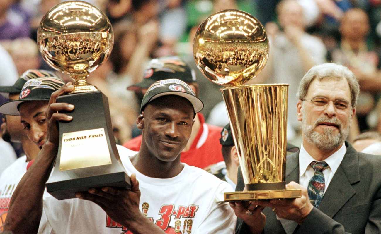 Michael Jordan and Chicago Bulls head coach Phil Jackson holding Most Valuable Player trophy