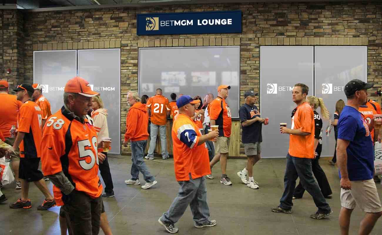 Denver Broncos fans walking past the BetMGM lounge at Empower Field at Mile High Stadium.