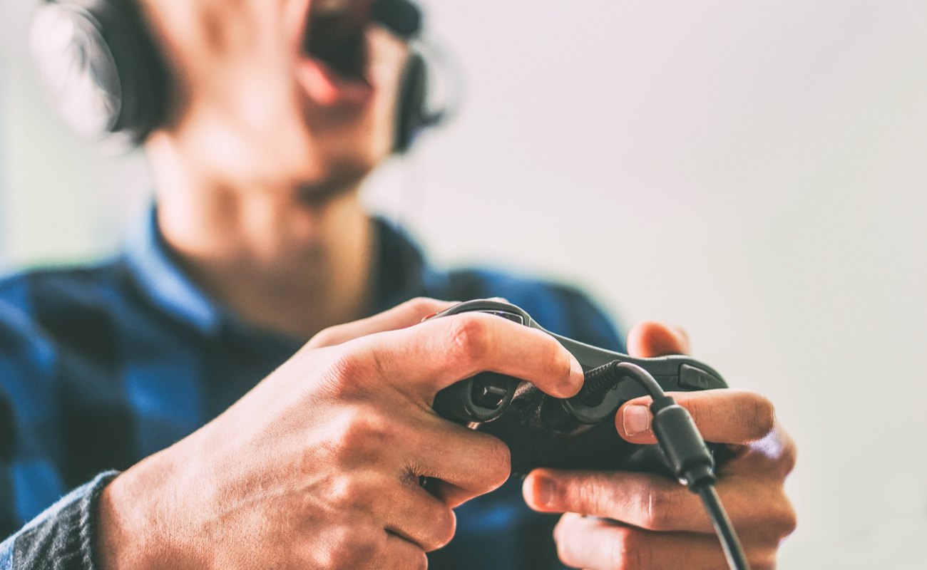Close up male hands gamer holding a joystick