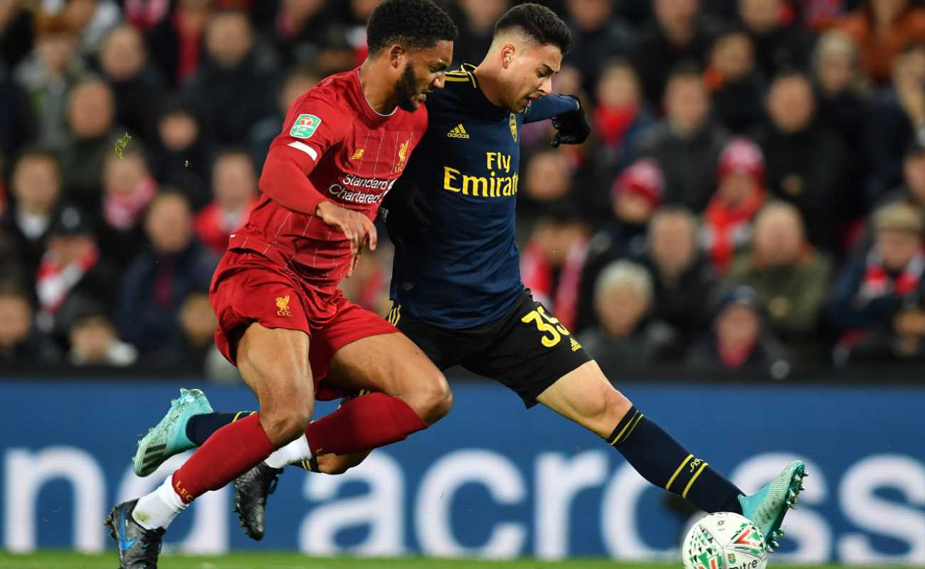 Liverpool defender, Joe Gomez, goes in to tackle Arsenal strike Gabriel Martinelli who has the ball