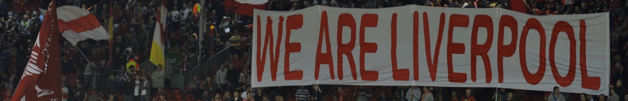 Fans hold up a “We Are Liverpool” sign during a game at Anfield