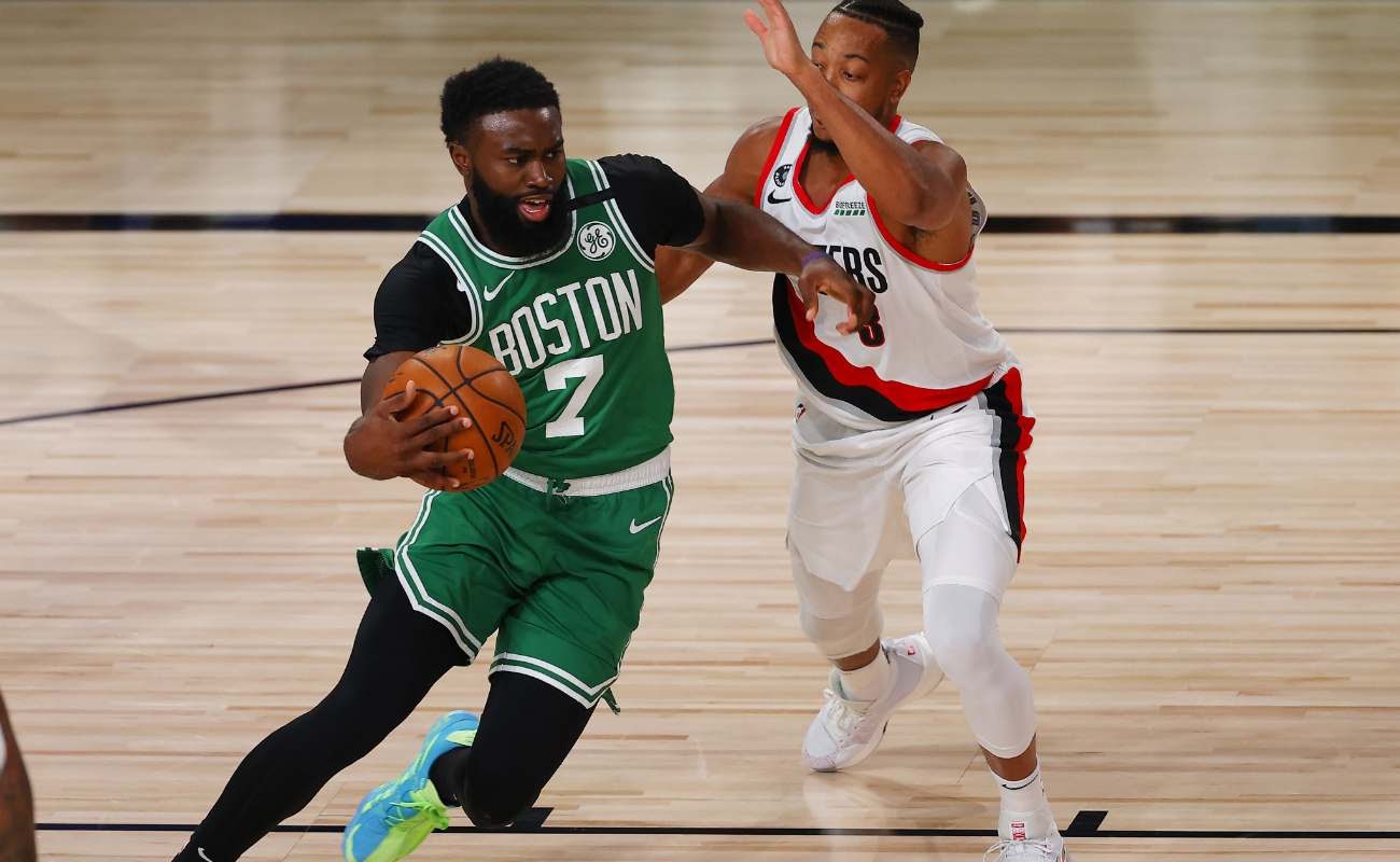 CJ McCollum of Portland Trail Blazers defends against Jaylen Brown of Boston Celtics at ESPN Wide World Of Sports Complex in August 2020