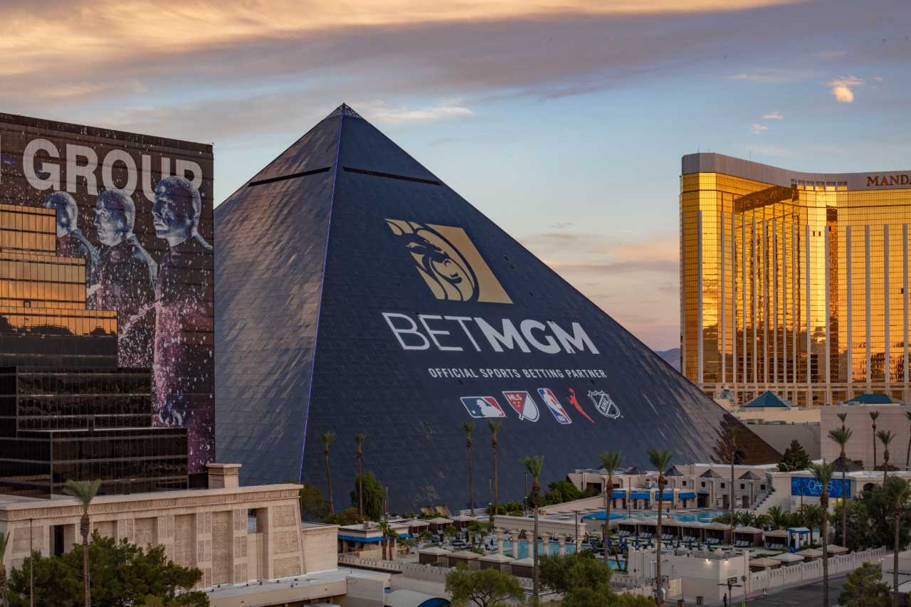 The new BetMGM ad wrap on the Luxor hotel at dusk.