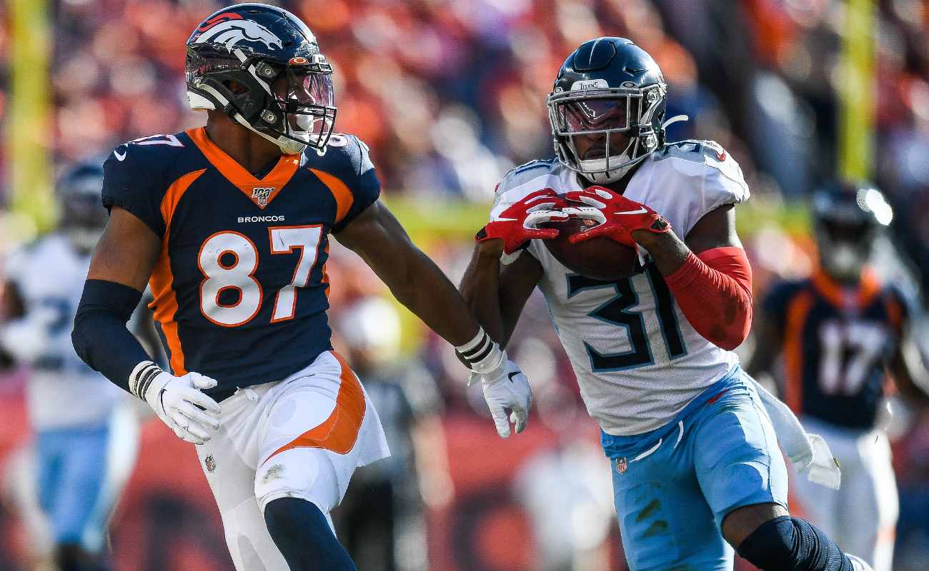 Kevin Byard of Tennessee Titans against Noah Fant of Denver Broncos during game at Empower Field