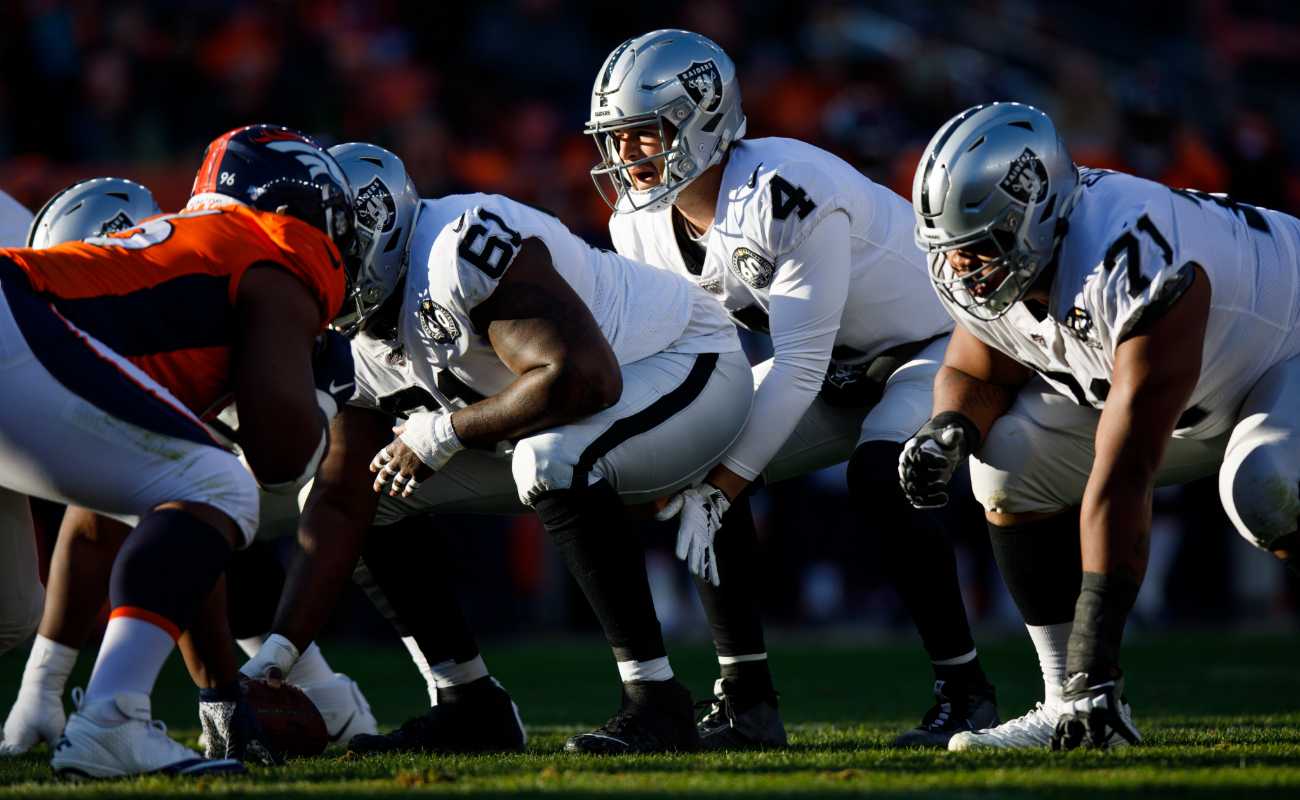 Quarterback Derek Carr of Las Vegas Raiders under center against Denver Broncos at Empower Field