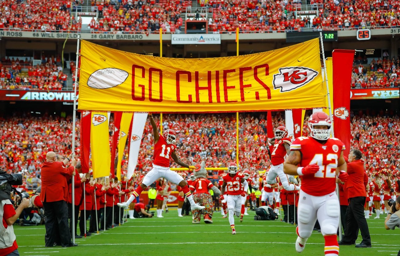 Demarcus Robinson #11 of the Kansas City Chiefs and Mecole Hardman #17 of the Kansas City Chiefs leap to touch the player introduction banner at the start of the game against the Baltimore Ravens at Arrowhead Stadium on September 22, 2019 in Kansas City, Missouri