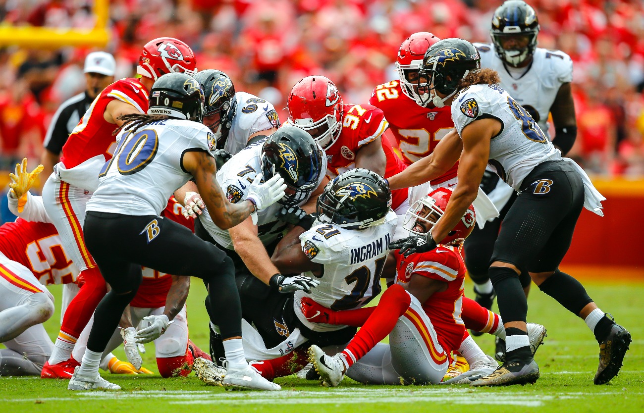 Mark Ingram #21 of the Baltimore Ravens lunges for extra yards while being tackled by Kendall Fuller #29 of the Kansas City Chiefs at Arrowhead Stadium on September 22, 2019 in Kansas City, Missouri
