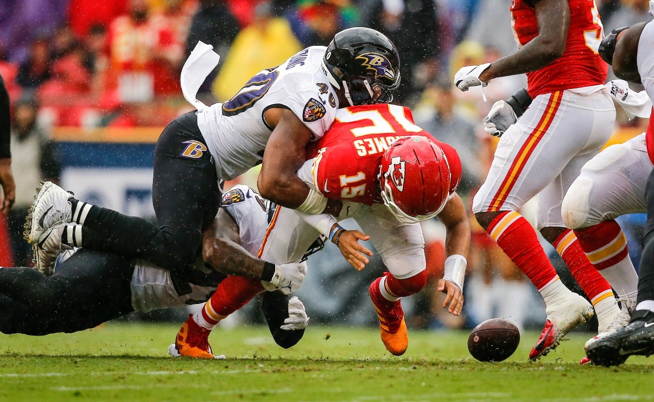 Patrick Mahomes #15 of the Kansas City Chiefs fumbles after being hit by Kenny Young #40 of the Baltimore Ravens on a fourth down play in the third quarter at Arrowhead Stadium on September 22, 2019 in Kansas City, Missouri.