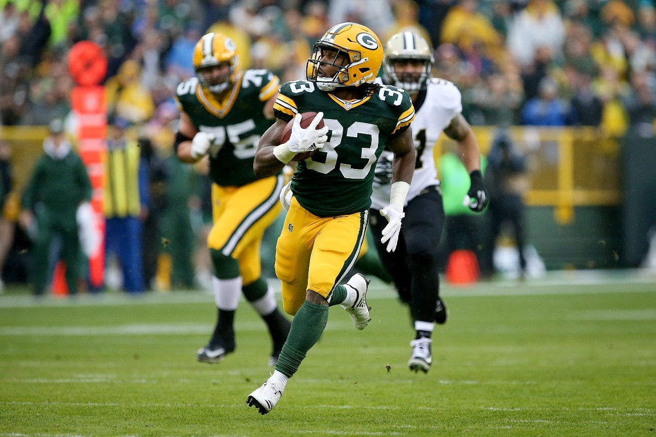 Aaron Jones #33 of the Green Bay Packers runs with the ball in the first quarter against the New Orleans Saints at Lambeau Field on October 22, 2017 in Green Bay, Wisconsin.