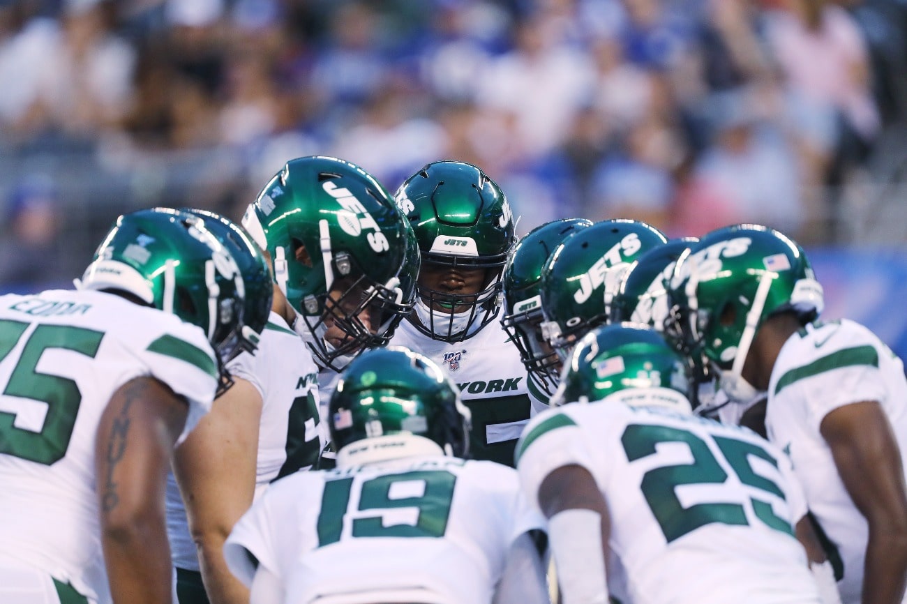 Tackle Eric Smith #65 of the New York Jets in the huddle against the New York Giants during their Preseason game at MetLife Stadium on August 08, 2019 in East Rutherford, New Jersey.