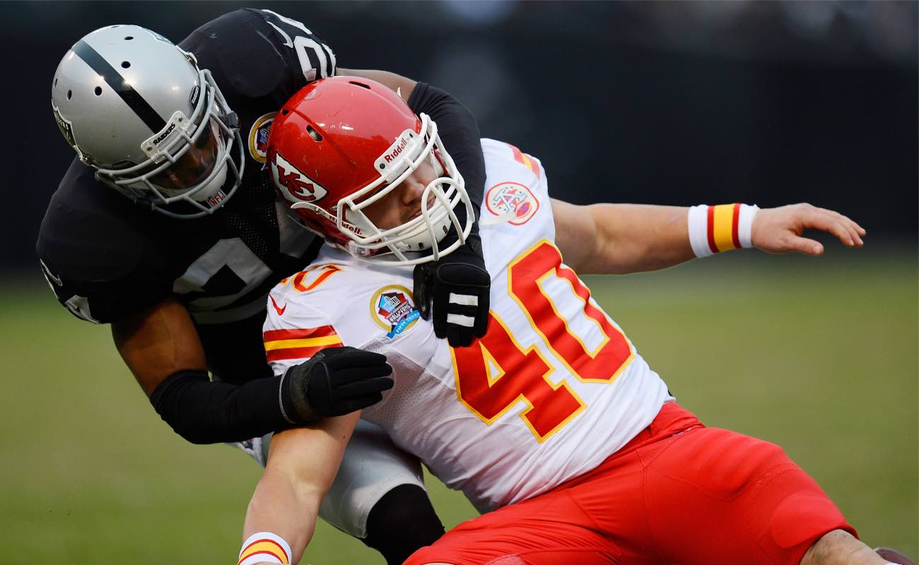 Michael Huff of Oakland Raiders against Peyton Hillis of Kansas City Chiefs at Oakland-Alameda County Coliseum